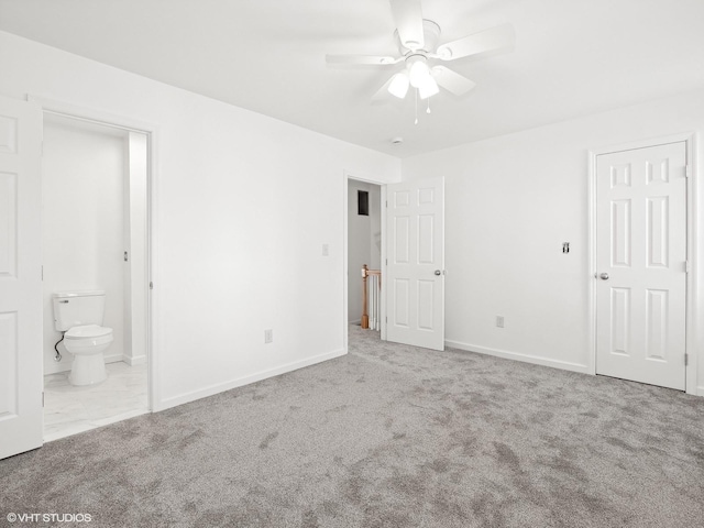 unfurnished bedroom with connected bathroom, light colored carpet, and ceiling fan