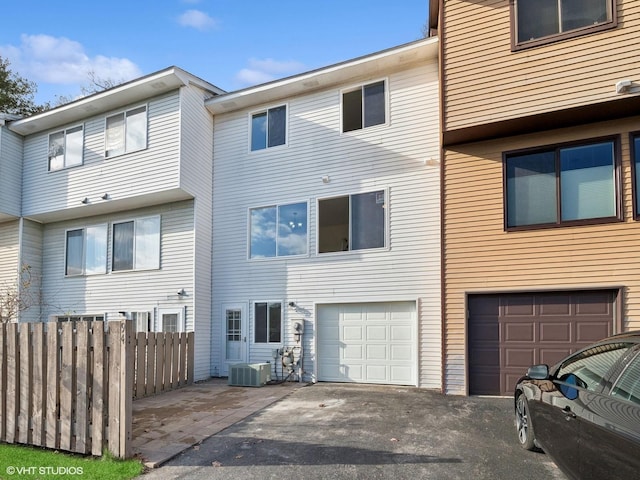 exterior space featuring central AC unit and a garage