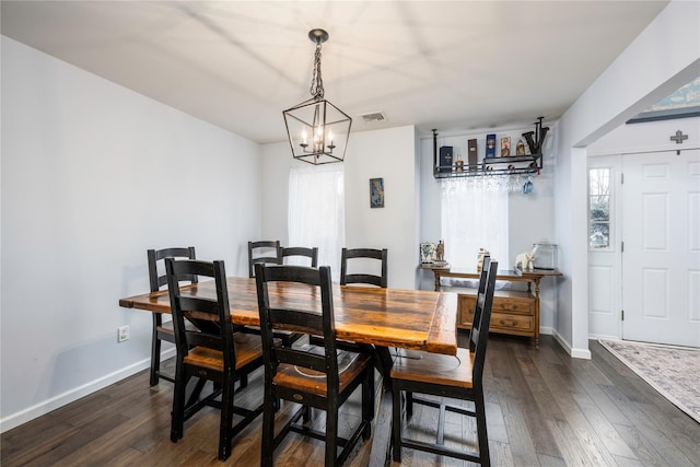 dining room featuring dark hardwood / wood-style floors and a chandelier