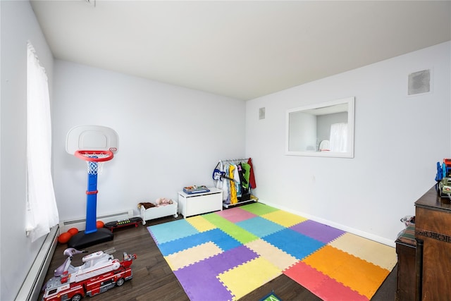 playroom featuring hardwood / wood-style flooring and a baseboard radiator