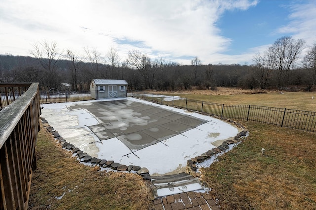 view of swimming pool featuring a shed, a lawn, and a patio