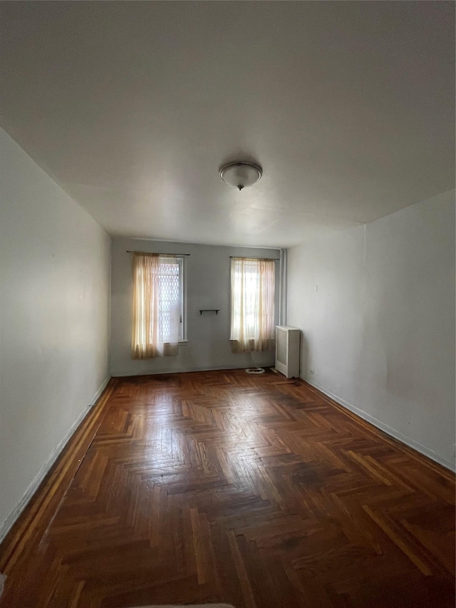 empty room with dark parquet floors