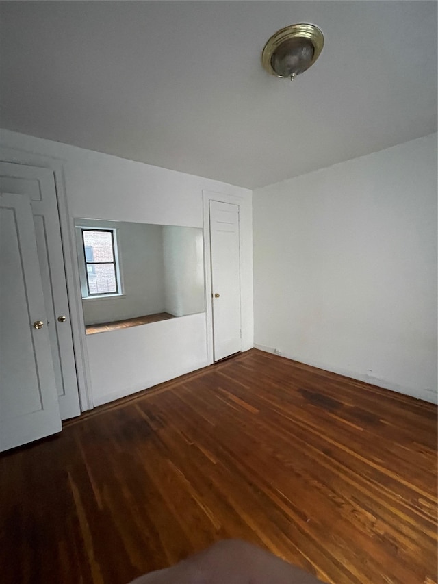 empty room with dark hardwood / wood-style floors