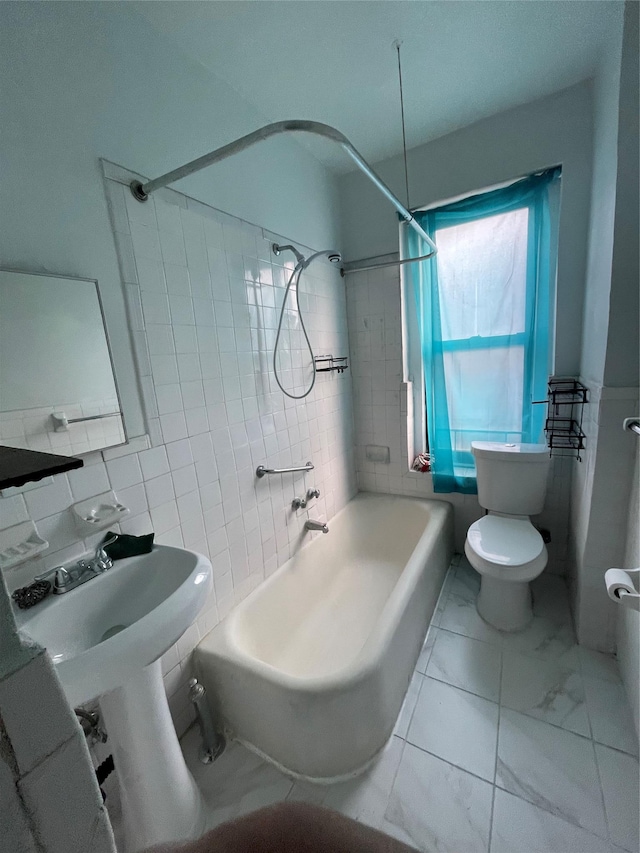 bathroom featuring decorative backsplash, toilet, tile walls, and shower / tub combo