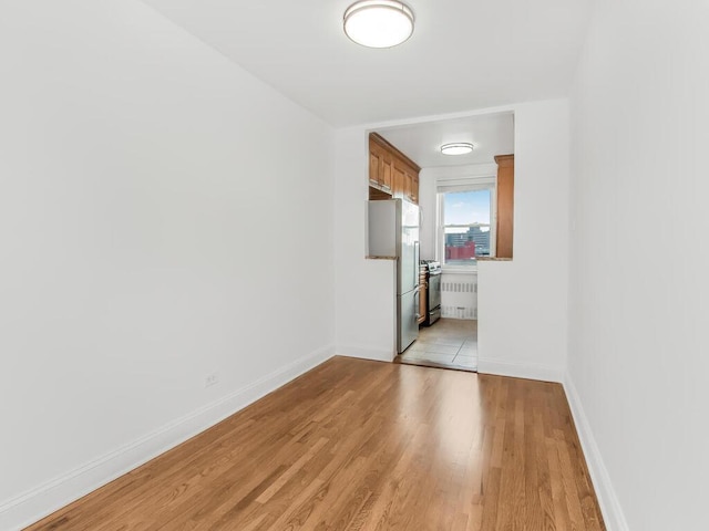 unfurnished room with light hardwood / wood-style flooring