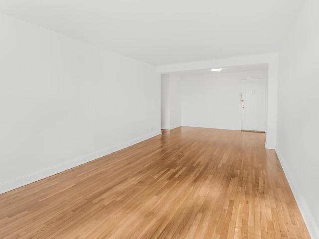 empty room with light hardwood / wood-style flooring