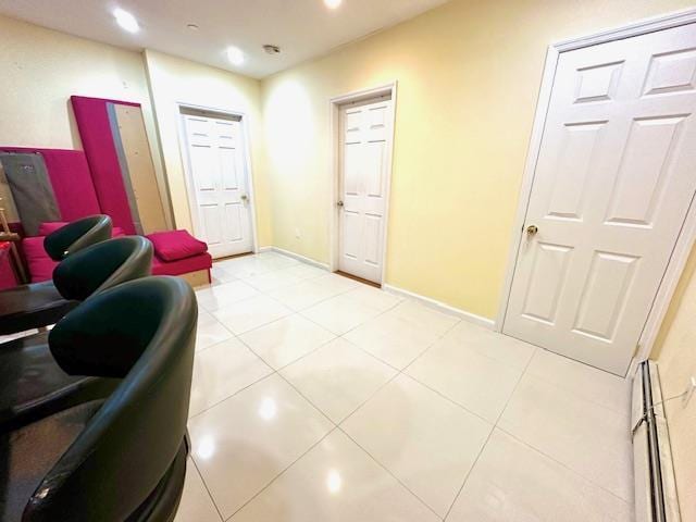 interior space featuring light tile patterned floors and a baseboard radiator