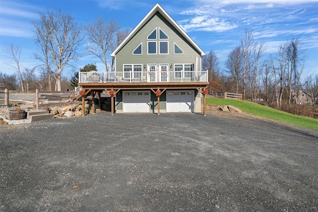 view of front of property featuring a garage and a wooden deck