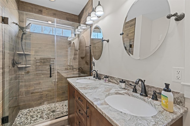 bathroom featuring vanity and a shower with shower door