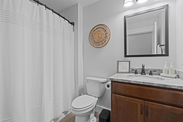 bathroom with hardwood / wood-style floors, vanity, and toilet