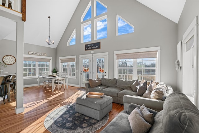 living room featuring hardwood / wood-style floors, a high ceiling, and a chandelier