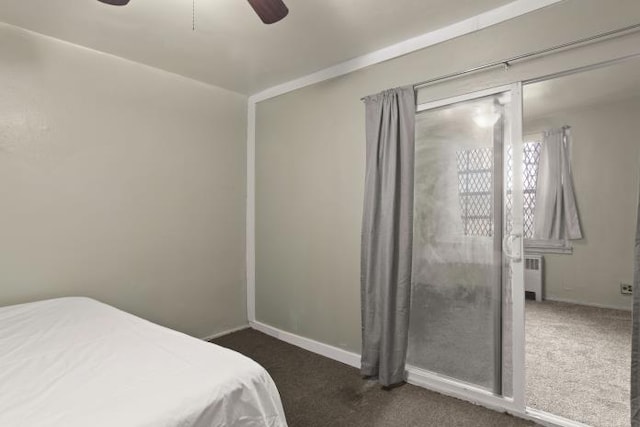 bedroom featuring radiator, ceiling fan, and dark carpet