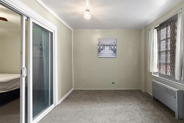 carpeted empty room featuring radiator