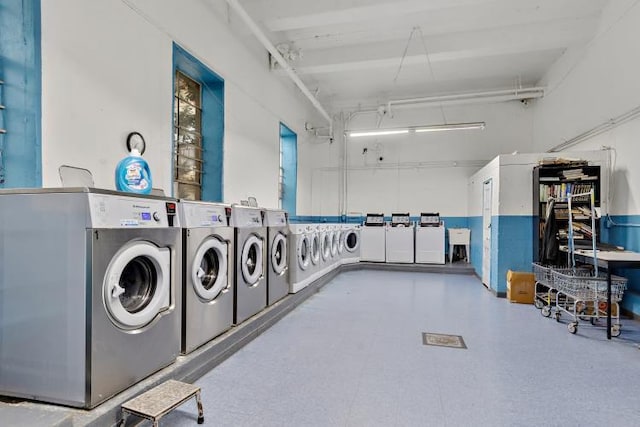 clothes washing area with separate washer and dryer