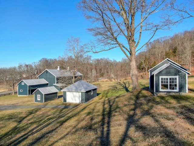 view of yard with an outbuilding, a pole building, and a garage