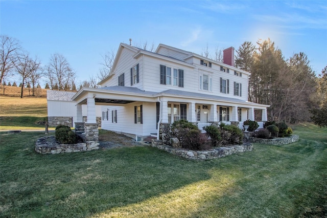 view of front facade featuring a front yard, a porch, and a chimney