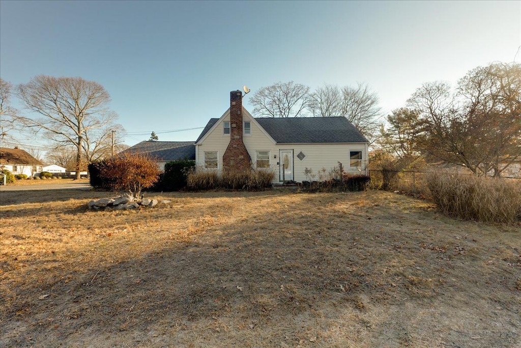 view of side of home with a lawn