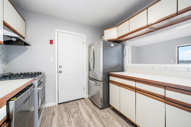 kitchen with white cabinetry, light wood-type flooring, and appliances with stainless steel finishes