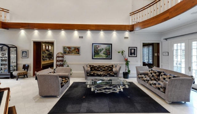 living room featuring light tile patterned floors, ornamental molding, and french doors