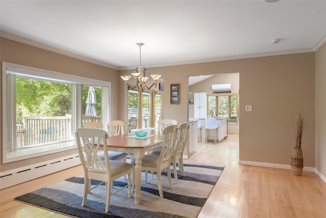 dining space with a wall unit AC, plenty of natural light, light hardwood / wood-style floors, and ornamental molding