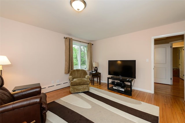 living room with hardwood / wood-style flooring and a baseboard heating unit