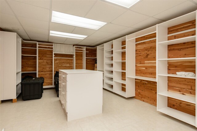 walk in closet featuring a paneled ceiling and light tile patterned flooring