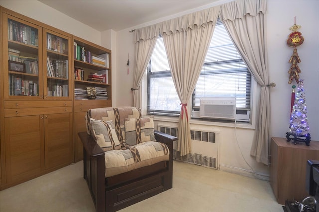 sitting room with light carpet and radiator heating unit