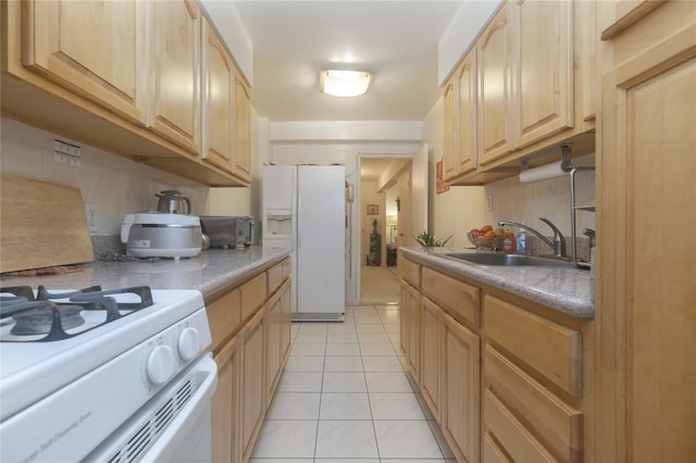 kitchen with light brown cabinets, white appliances, light tile patterned floors, and sink