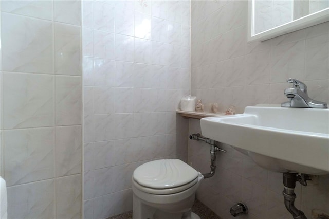 bathroom with backsplash, toilet, and tile walls