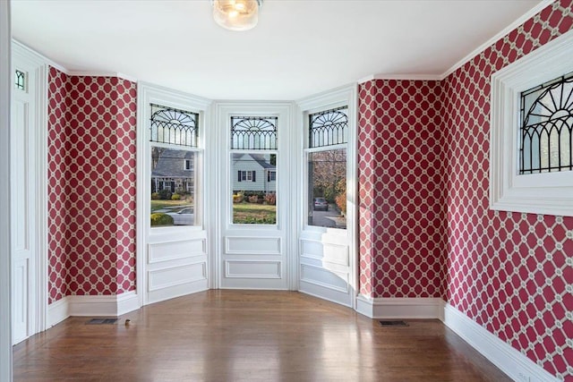 spare room with wood-type flooring and ornamental molding