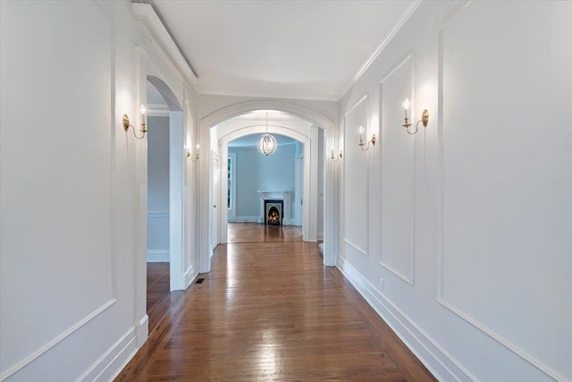 corridor featuring crown molding and dark wood-type flooring