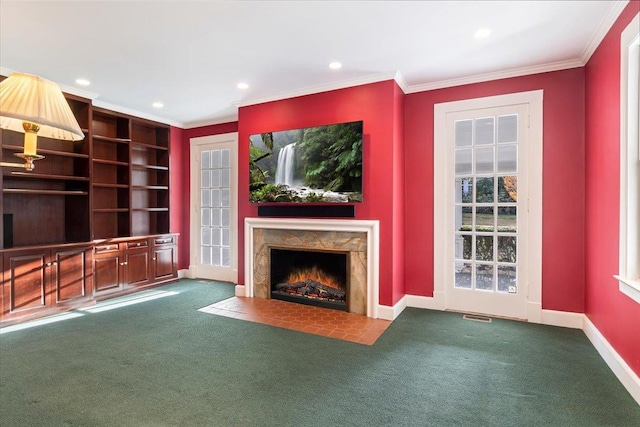 unfurnished living room featuring carpet flooring, crown molding, and a premium fireplace