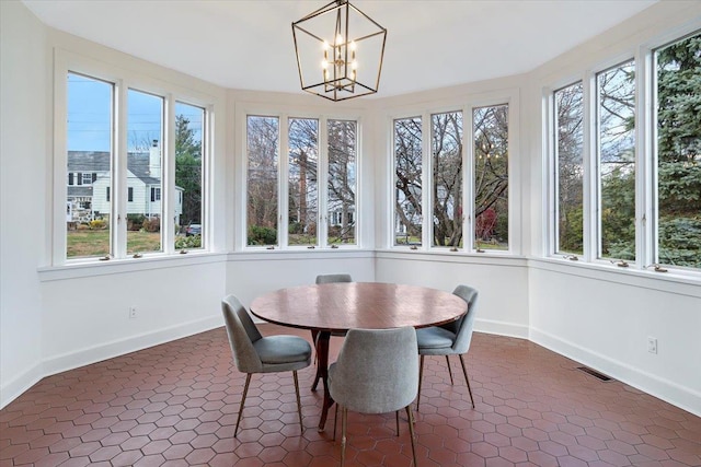 sunroom featuring a chandelier