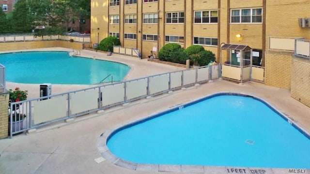 view of pool featuring a patio