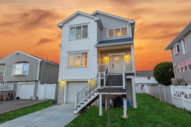 view of front facade featuring a lawn and a garage