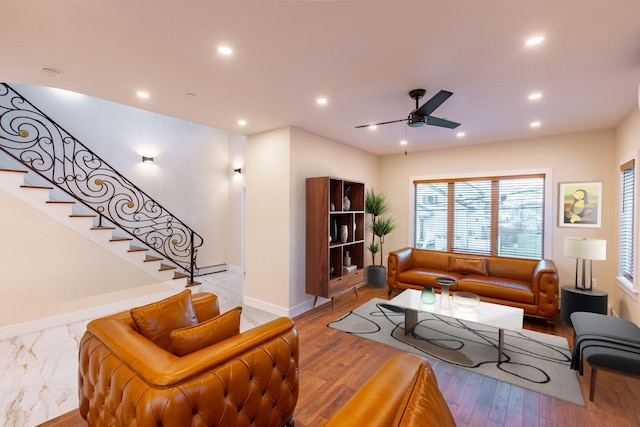 living room featuring light wood-type flooring and ceiling fan