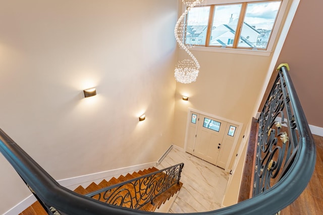 stairway featuring a chandelier