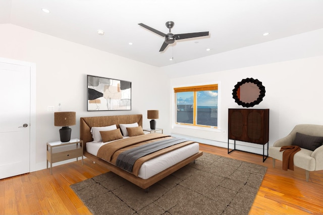 bedroom featuring hardwood / wood-style flooring, ceiling fan, and lofted ceiling