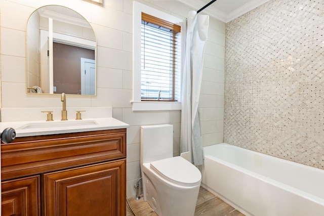 full bathroom with vanity, shower / tub combo with curtain, crown molding, tile walls, and toilet