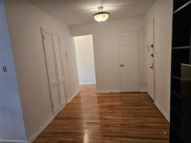 corridor featuring dark hardwood / wood-style floors