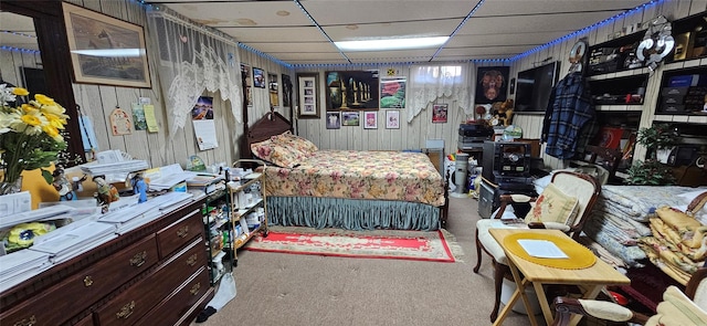 bedroom featuring a paneled ceiling and carpet