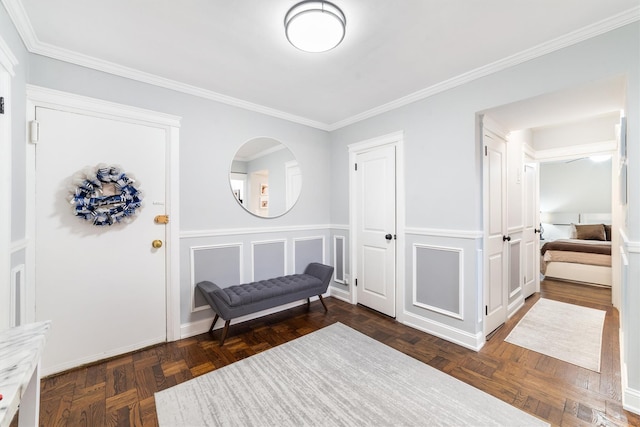 sitting room featuring dark parquet flooring and crown molding