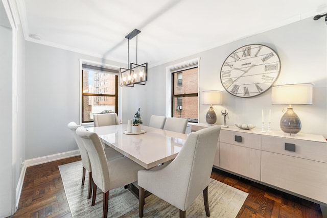 dining room featuring dark parquet floors and ornamental molding