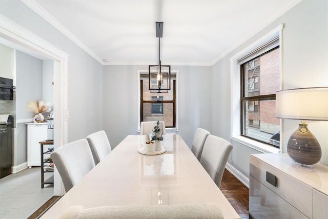 dining area with light parquet floors and crown molding