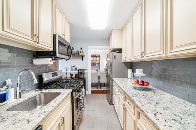 kitchen featuring appliances with stainless steel finishes and cream cabinets