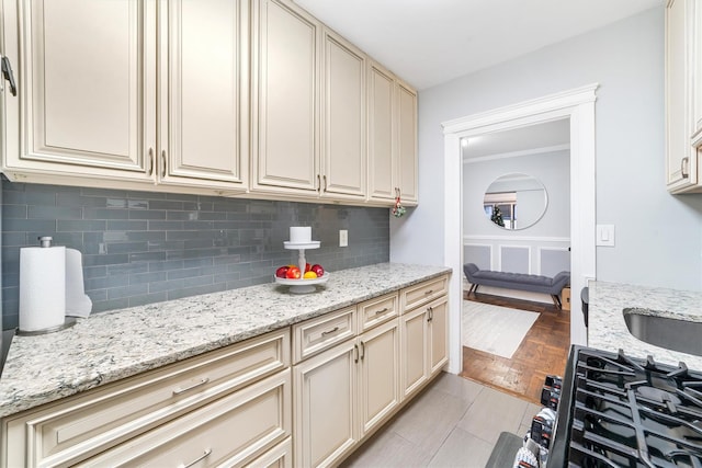 kitchen featuring light stone counters, tasteful backsplash, and cream cabinets