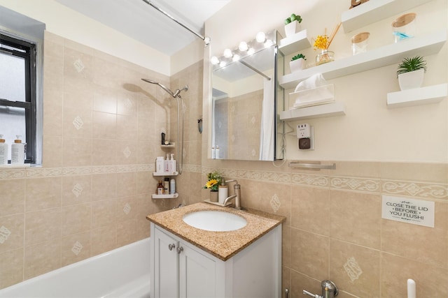 bathroom featuring vanity, tiled shower / bath combo, and tile walls