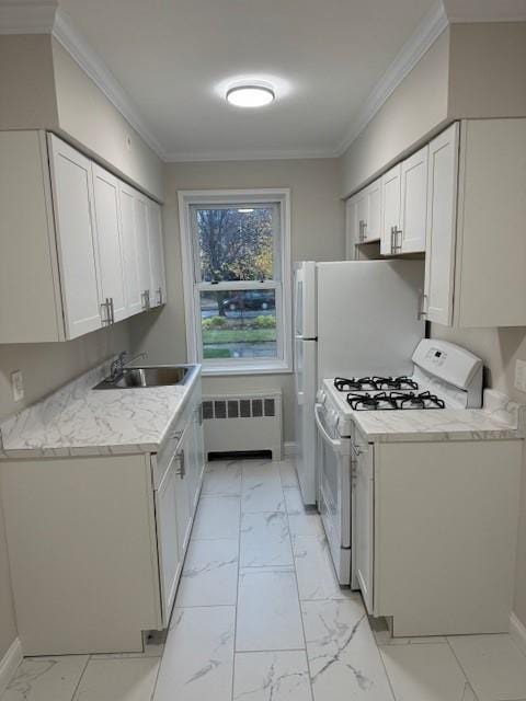 kitchen featuring sink, radiator heating unit, white gas range oven, ornamental molding, and white cabinetry