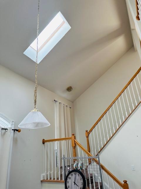 stairway featuring a skylight