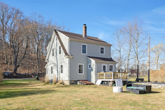 back of house featuring a yard and a deck